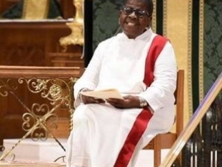 AnnaMarie seated in Anna Vestments